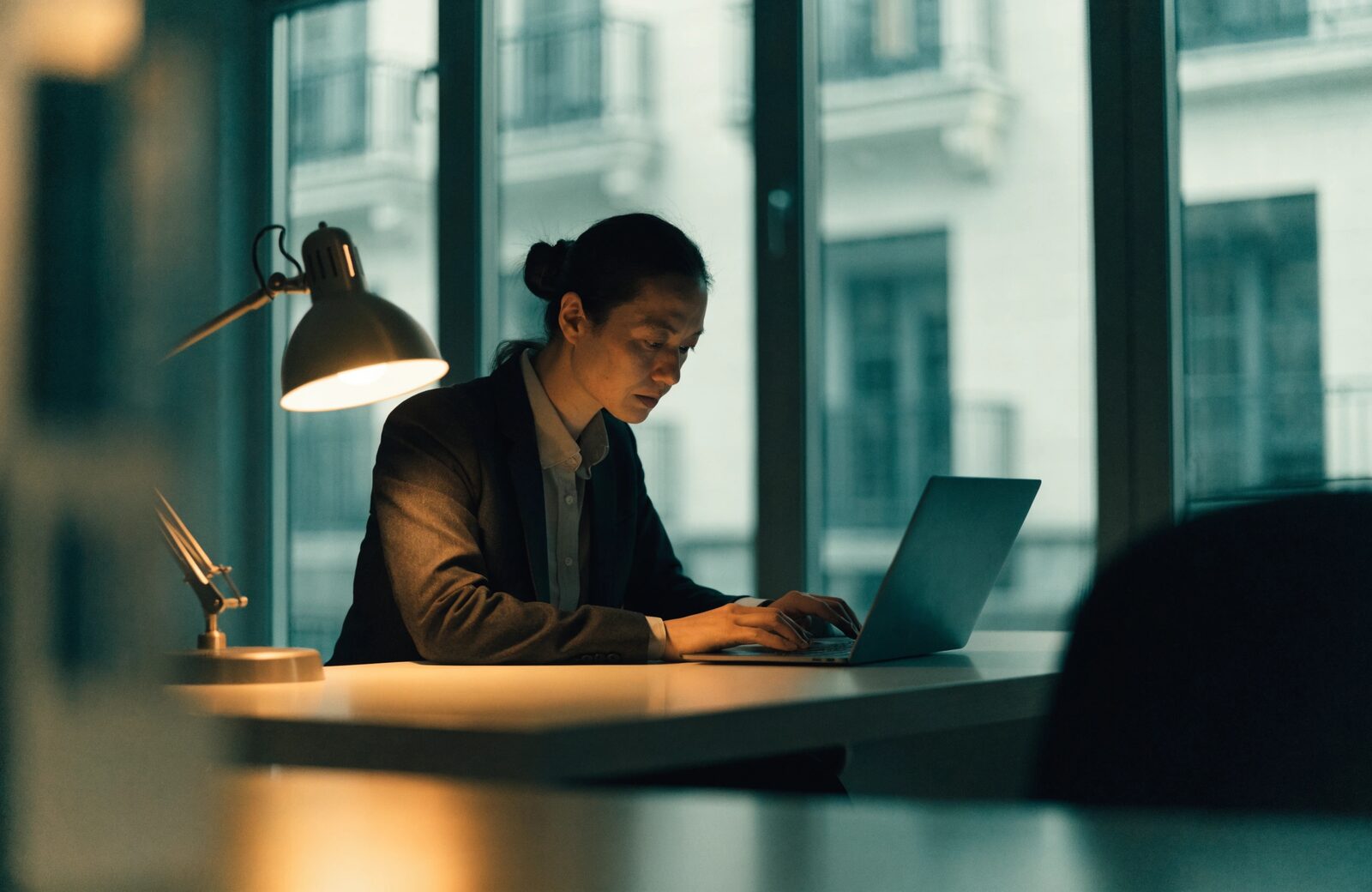 A professional working in deep focus at a laptop.